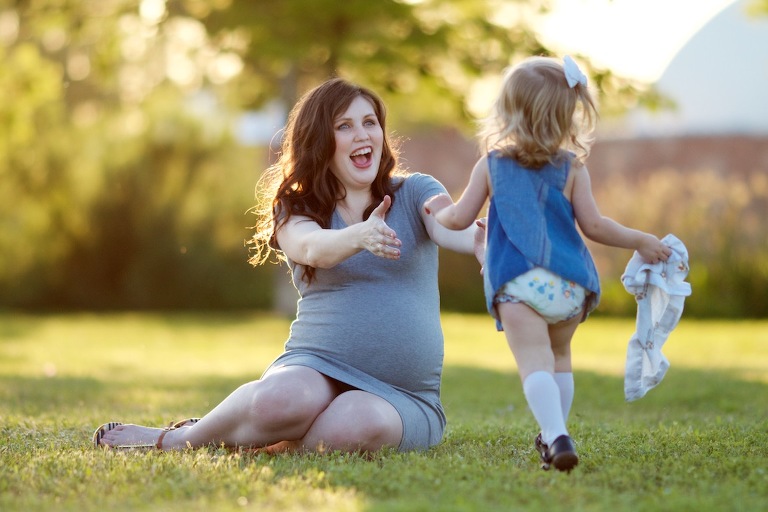 Daughter running into pregnant mom's arms