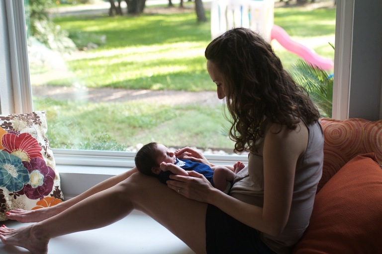 Mom by window with baby