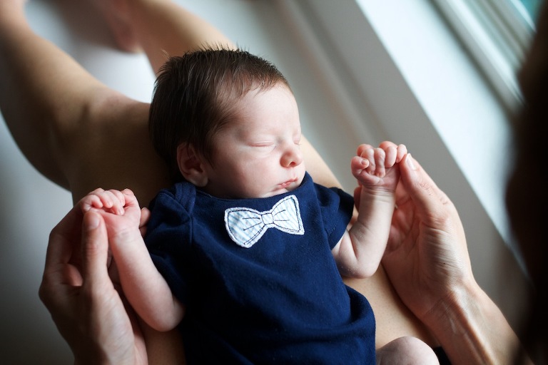 Newborn baby in moms lap 