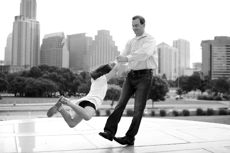 Dad swinging daughter with downtown Austin in background