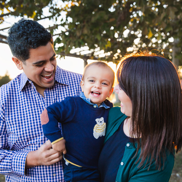 Family of 3 tickling baby boy