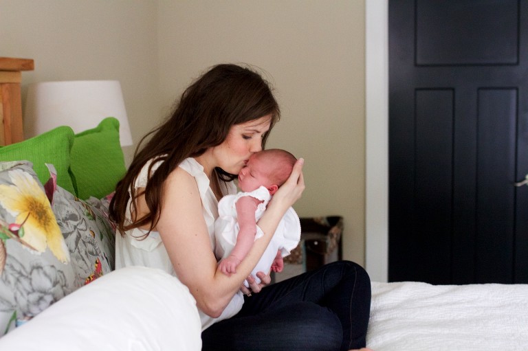 Mom kissing newborn baby